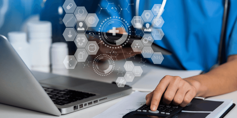 Person in medical scrubs using a laptop and calculator with medical icons overlaid